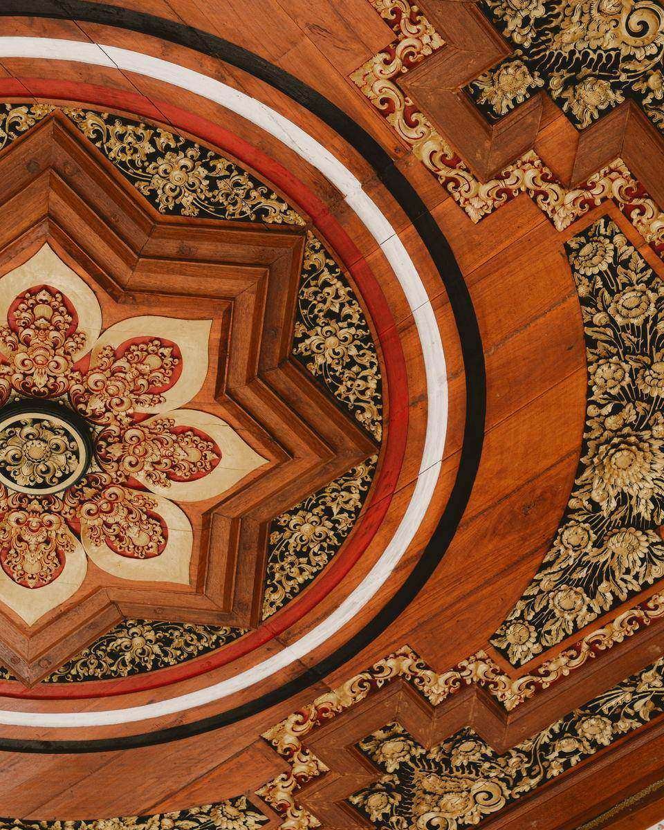 Carved and gilded Balinese ceiling, lotus centre with red, white and black rings