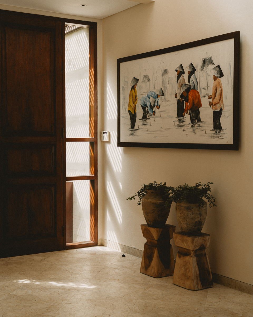 Villa entrance hall with framed rice-field painting and louvred light on the wall